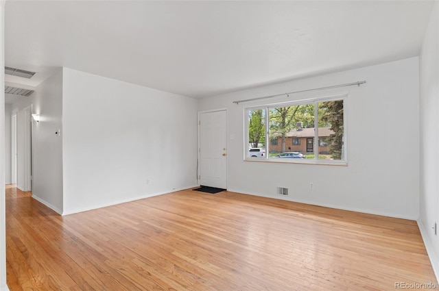 empty room with light wood-style flooring and baseboards