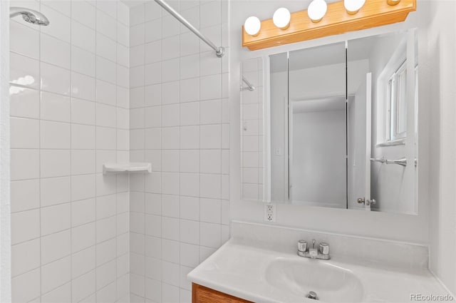 full bathroom featuring vanity and a tile shower