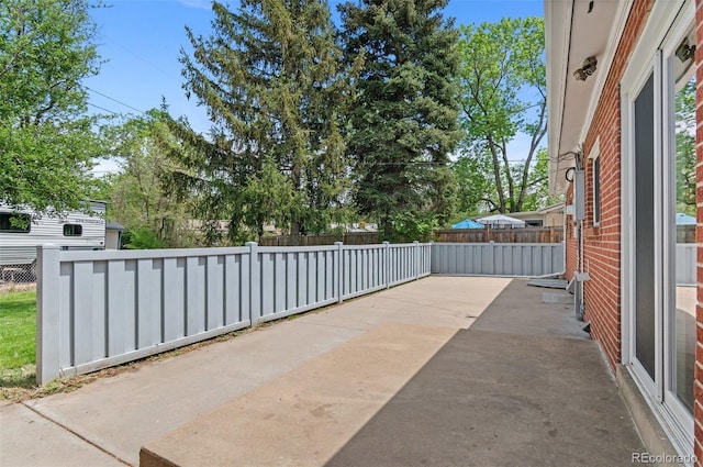 view of patio / terrace featuring fence