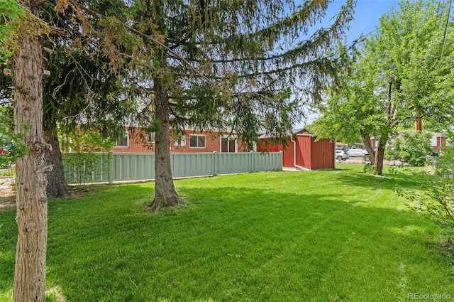view of yard featuring a shed and an outbuilding