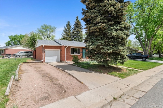 view of front of home with a garage, brick siding, and driveway