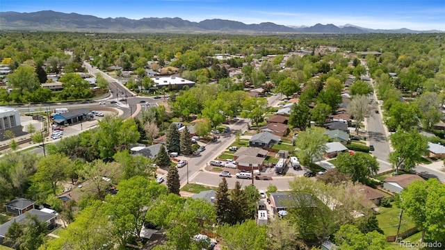 view of property location featuring mountains and nearby suburban area