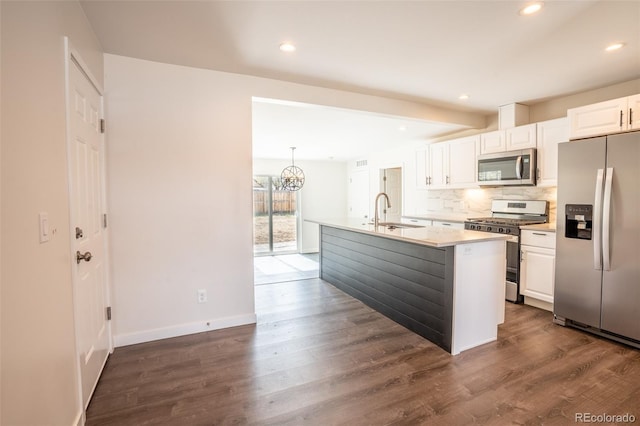 kitchen with tasteful backsplash, dark wood-style floors, white cabinetry, stainless steel appliances, and a sink