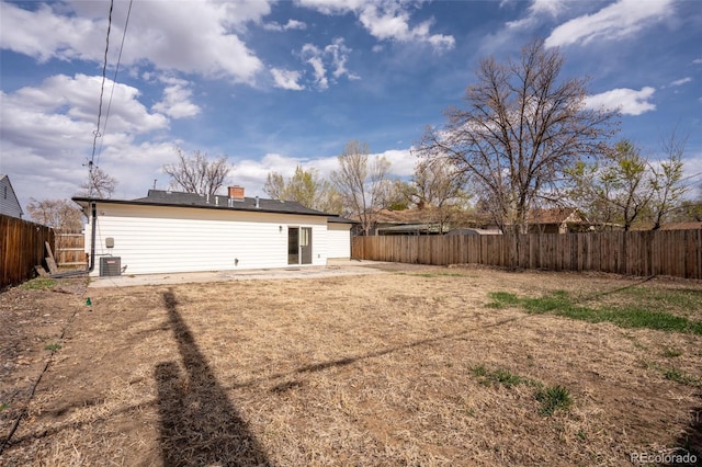 back of property with a patio, central AC unit, and a fenced backyard