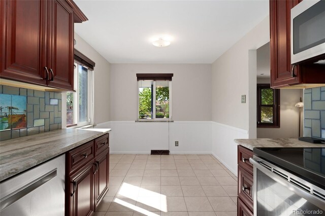 2692 S Pennsylvania St, Denver, CO 80210 - kitchen featuring decorative backsplash, appliances with stainless steel finishes, dark brown cabinets, and light stone countertops