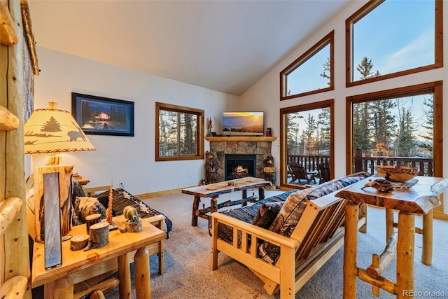 living room featuring a healthy amount of sunlight, carpet floors, a fireplace, and high vaulted ceiling