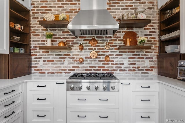 kitchen with open shelves, stainless steel gas cooktop, exhaust hood, and white cabinets