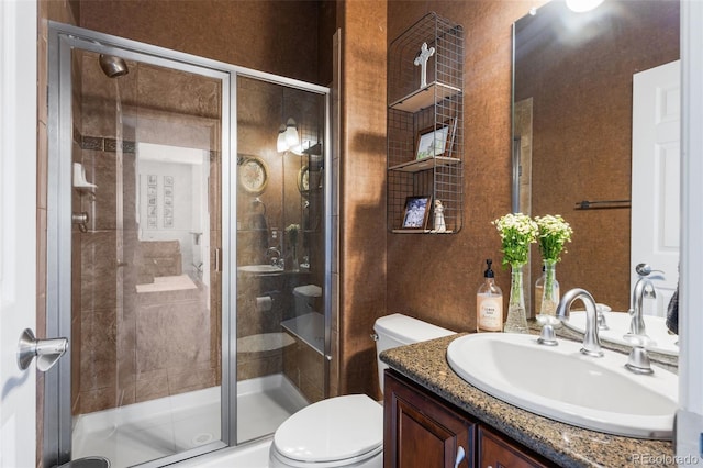 full bath with toilet, a shower stall, and vanity