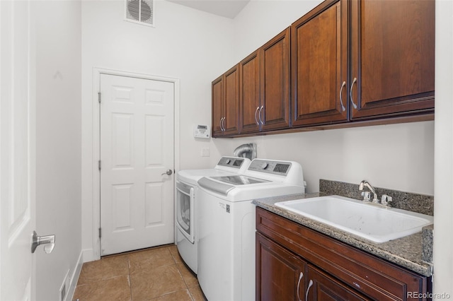 laundry area with washer and clothes dryer, cabinet space, light tile patterned floors, and baseboards