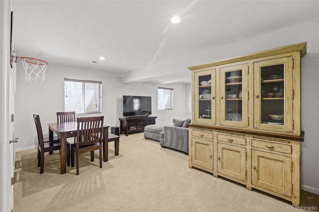 dining space featuring light colored carpet, recessed lighting, and baseboards
