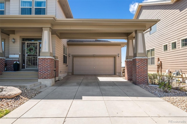 property entrance featuring a garage, concrete driveway, and brick siding