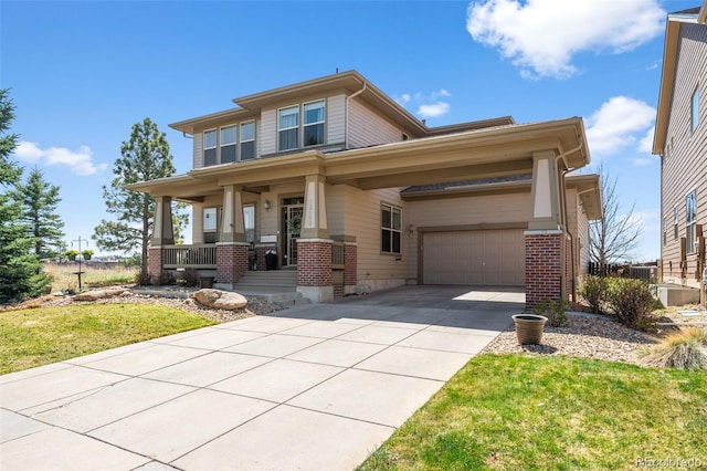 view of front of home with covered porch, brick siding, concrete driveway, and a front yard