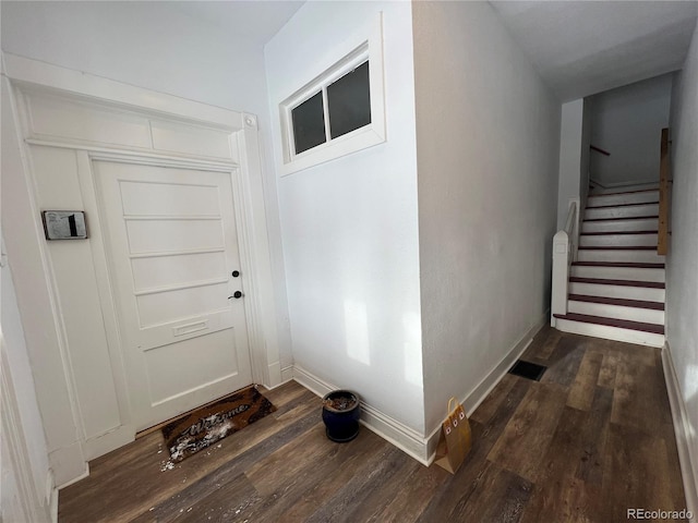 doorway to outside featuring dark wood-type flooring