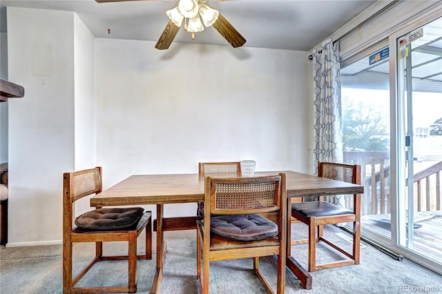 dining space featuring carpet flooring, a ceiling fan, and baseboards