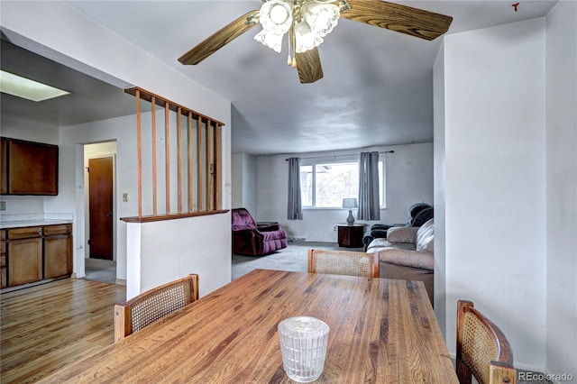 dining area featuring light wood-type flooring and ceiling fan