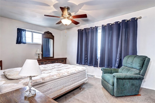 carpeted bedroom with baseboards, visible vents, and ceiling fan