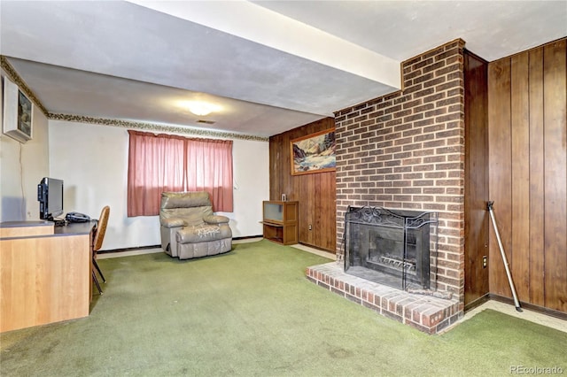 living area featuring visible vents, baseboards, wood walls, a brick fireplace, and carpet flooring