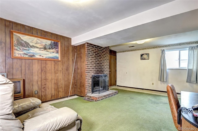 living area with wooden walls, carpet flooring, and a fireplace