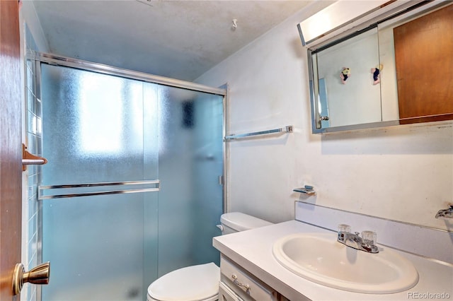 full bath featuring vanity, toilet, and a shower stall