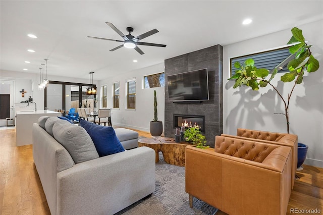 living area with recessed lighting and light wood finished floors