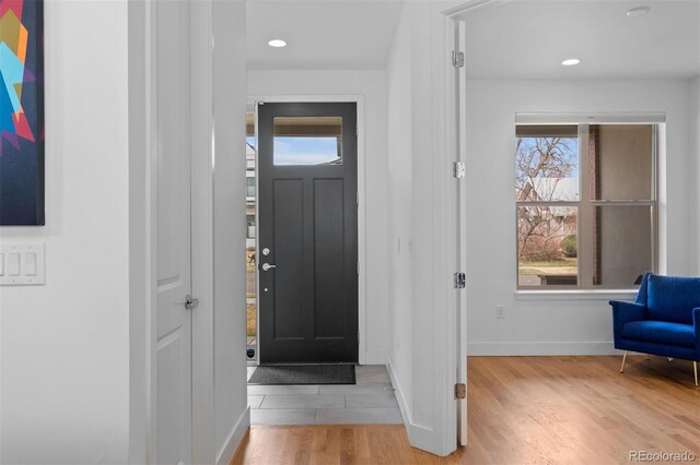 entryway with baseboards, recessed lighting, and wood finished floors