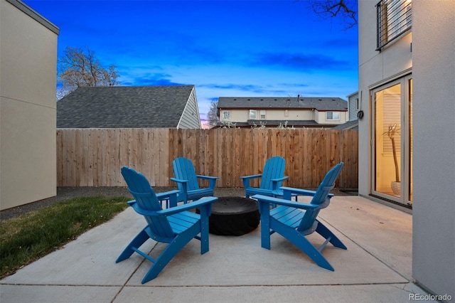 patio terrace at dusk with fence and a fire pit