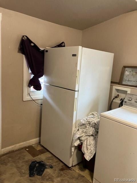 615 E 49th Ave, Denver, CO 80216 - kitchen featuring washer / clothes dryer, freestanding refrigerator, and baseboards