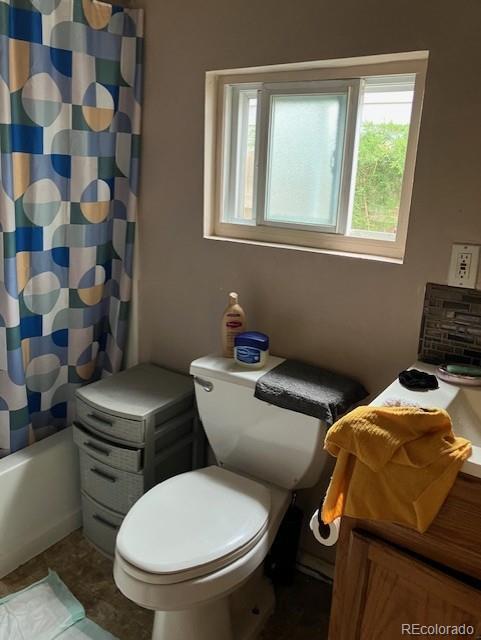 615 E 49th Ave, Denver, CO 80216 - bathroom with toilet and shower / bath combo with shower curtain