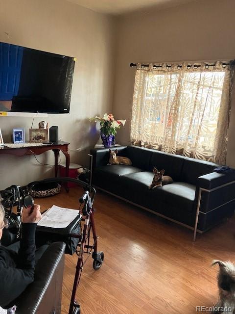 615 E 49th Ave, Denver, CO 80216 - living room featuring wood finished floors