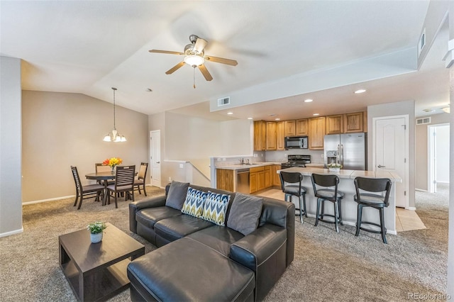 living room featuring visible vents, light carpet, and vaulted ceiling