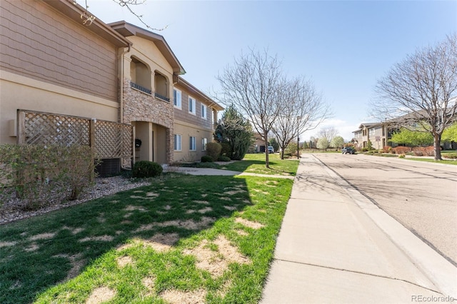 view of road featuring curbs, sidewalks, and a residential view