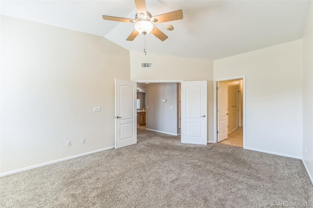unfurnished bedroom featuring a ceiling fan, light colored carpet, visible vents, baseboards, and lofted ceiling