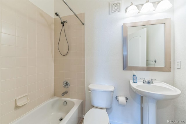 bathroom with toilet, visible vents, and bathtub / shower combination