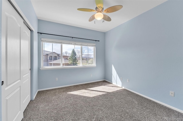 unfurnished bedroom featuring baseboards, carpet, and a closet