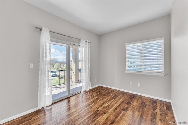 empty room with baseboards and wood finished floors