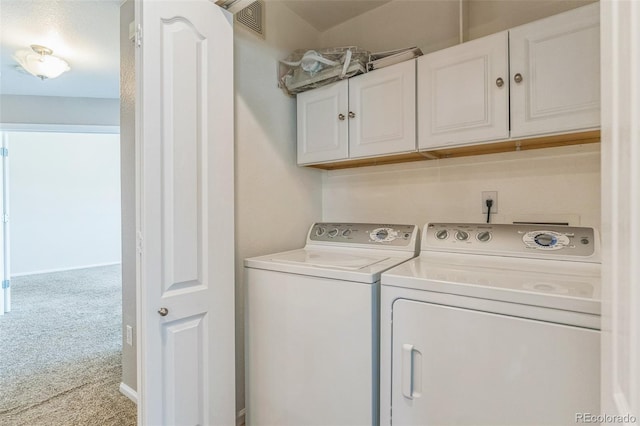 washroom featuring cabinet space, carpet flooring, visible vents, and washer and clothes dryer