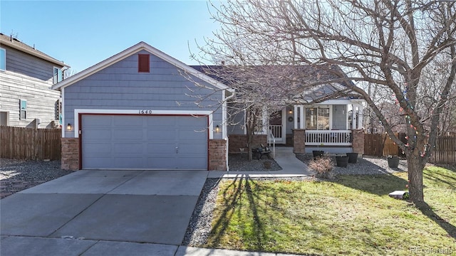 view of front of property featuring a front yard, a porch, and a garage