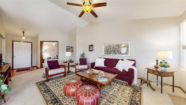 carpeted living room with ceiling fan, a healthy amount of sunlight, and vaulted ceiling