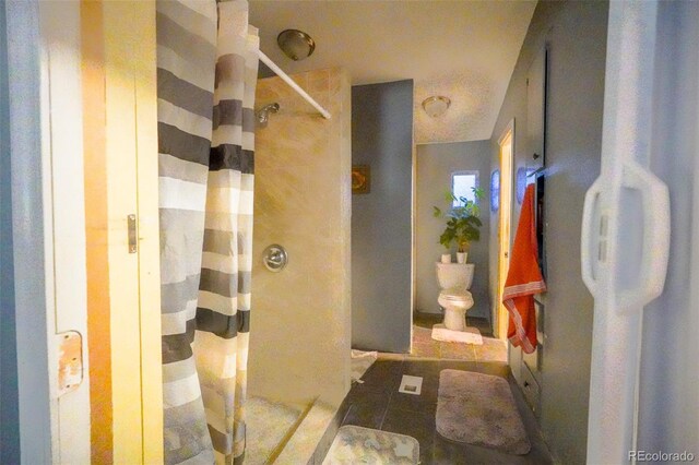 15682 Morris Ave, Fort Lupton, CO 80621 - bathroom with toilet, a stall shower, and tile patterned floors