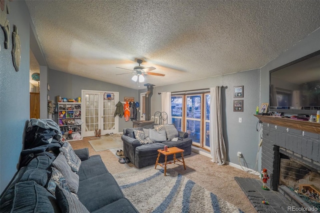 15682 Morris Ave, Fort Lupton, CO 80621 - carpeted living room featuring vaulted ceiling, a textured wall, a textured ceiling, a ceiling fan, and a fireplace