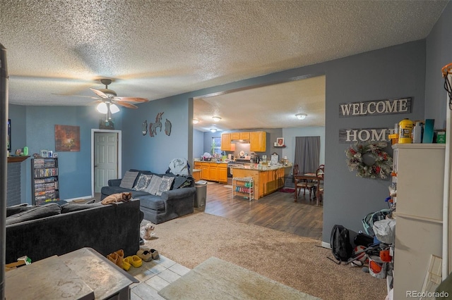 15682 Morris Ave, Fort Lupton, CO 80621 - living area featuring a textured ceiling, dark carpet, and ceiling fan