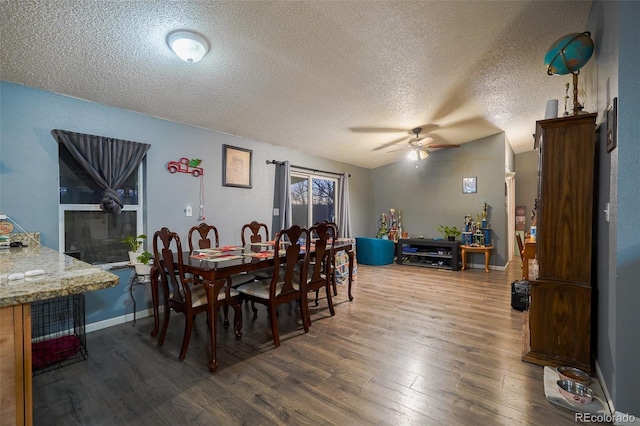 15682 Morris Ave, Fort Lupton, CO 80621 - dining room featuring dark wood finished floors, baseboards, ceiling fan, and a textured ceiling