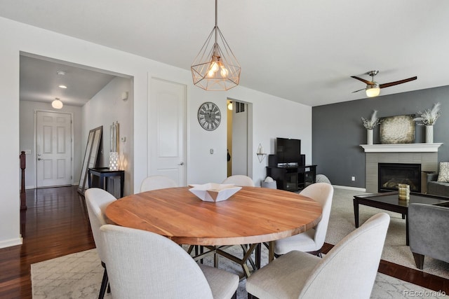 dining space with ceiling fan and dark hardwood / wood-style floors