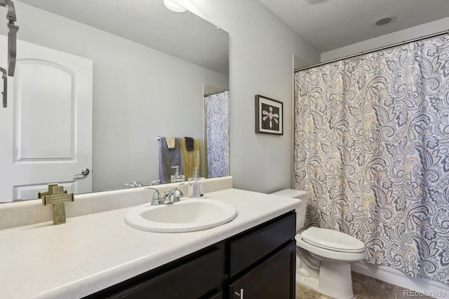 bathroom with vanity, toilet, and tile patterned flooring