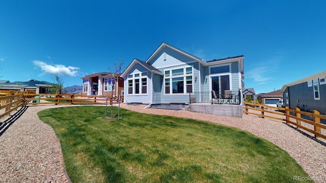 back of house with a lawn and a patio