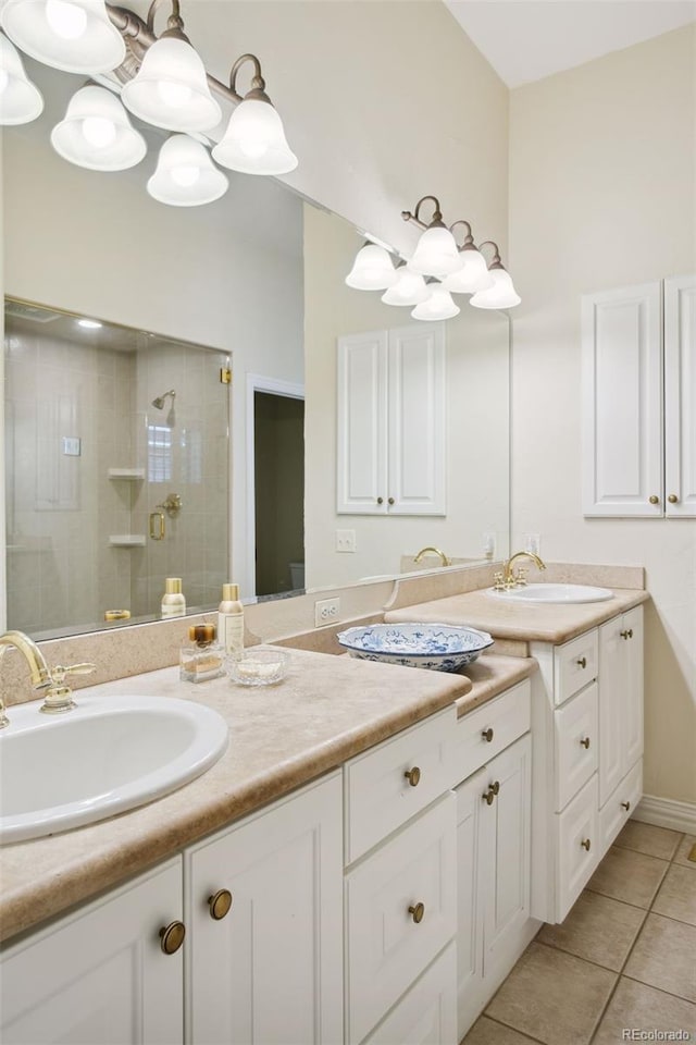 bathroom with tile patterned flooring, vanity, and an enclosed shower