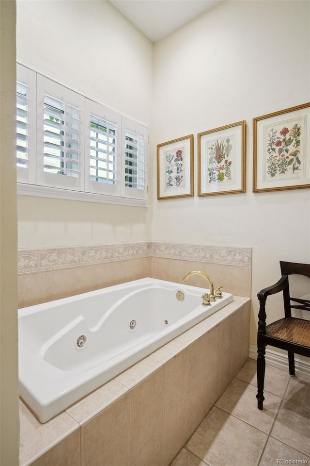 bathroom featuring tile patterned flooring and tiled bath