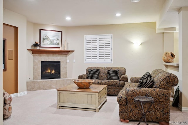 living room featuring light carpet and a fireplace