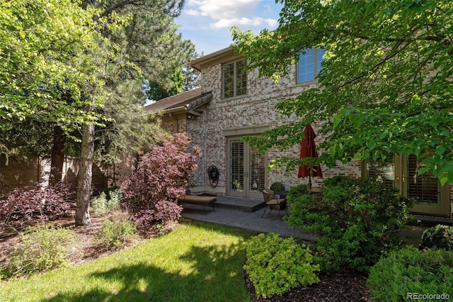 back of house with a yard, a patio area, and french doors