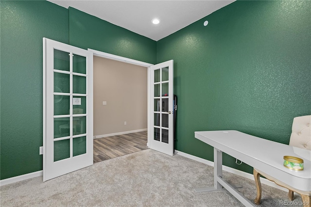 carpeted office featuring french doors